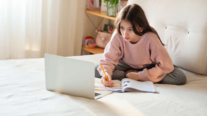 Student studying writing notes at home