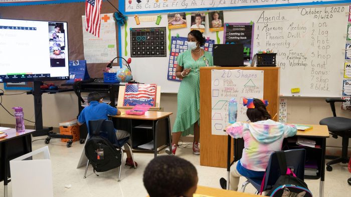 Boy and girl studies at home, wear protective masks, and doing school homework. Distance learning online education.